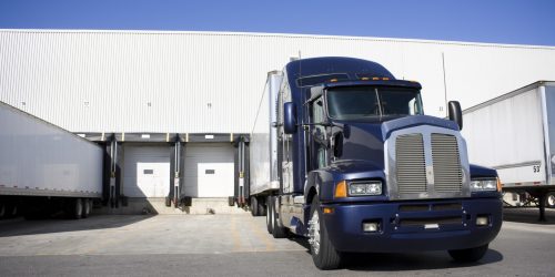 Blue Transport Truck Docking in warehouse